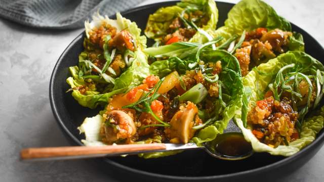 Vegetarian lettuce wraps with quinoa, mushrooms, red peppers, hoisin sauce, and butter lettuce. 