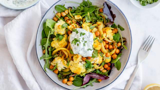 Roasted cauliflower and chickpeas on pita bread with yogurt sauce.