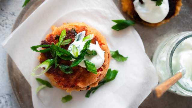 Salmon patties made with canned salmon, fresh herbs, breadcrumbs, and bell peppers cooked until golden brown.