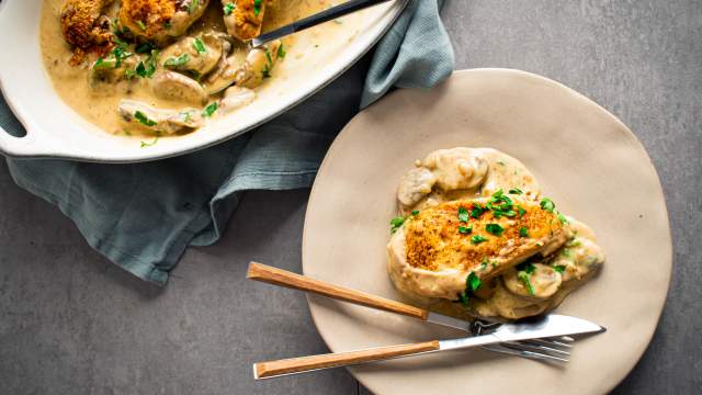 Slow cooker chicken marsala with chicken breast in a mushroom marsala sauce on a plate with parsley.