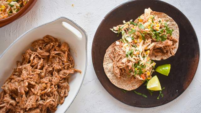 Slow Cooker Chorizo Spiced Pulled Pork in a corn tortilla with cabbage slaw.