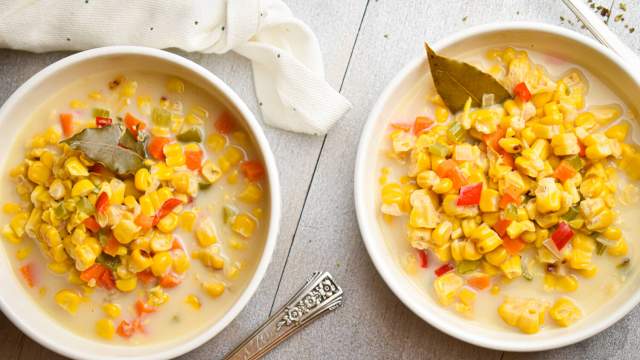 Slow cooker corn chowder with red peppers, carrots, celery, and poblano peppers in a creamy broth.