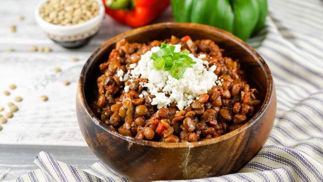 Slow cooker lentil sloppy joes with cheese in a wooden bowl.