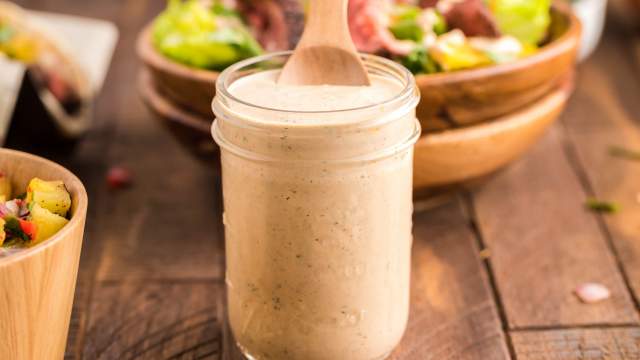 Southwest salad dressing in a glass jar with Greek yogurt, lime juice, taco seasoning, and salsa.