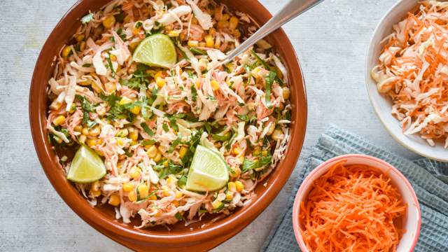 Spicy cabbage slaw with corn and shredded carrots in a creamy lime dressing.