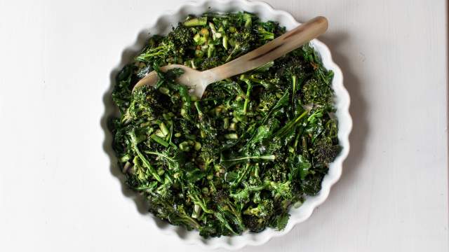 Stir fried Chinese broccoli chopped and cooked with garlic, ginger, and oyster sauce in a dish.