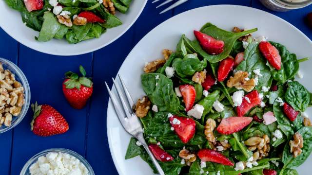 Strawberry spinach salad with poppyseed dressing, feta cheese, and walnuts.