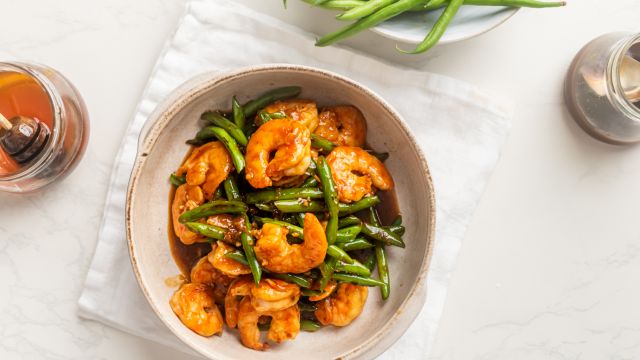 Teriyaki shrimp with green beans in a bowl with homemade teriyaki sauce. 