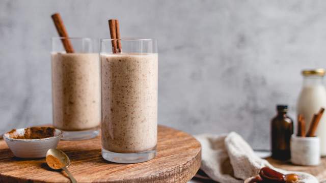 Vanilla cinnamon protein shake with bananas, cauliflower, protein, cinnamon, and almond butter poured in two glasses.