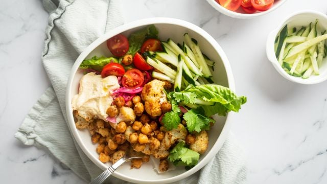 Vegetarain shawarma bowl with roasted chickpeas, cauliflower, and fresh vegetables.